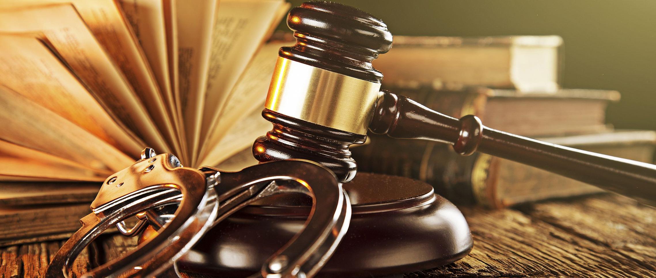 Wooden gavel and books on wooden table, law concept