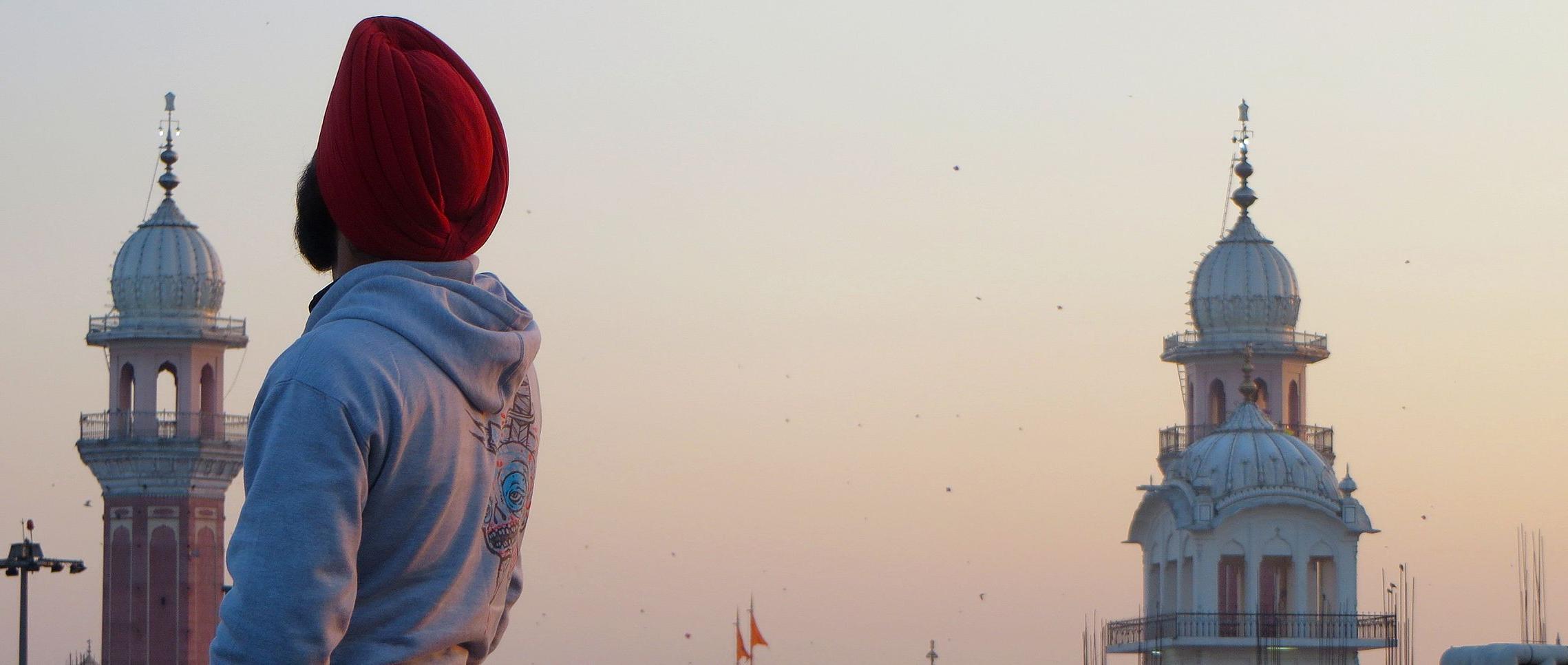 A photo taken during the India J-Term study tour in 2015. A student poses in front of landmarks in India.